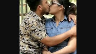 Indian girlfriend kisses her boyfriend while showcasing her sexy legs outdoors
