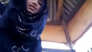 Young hijabi beauty shows off her alluring pussy