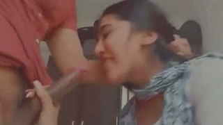 A young Indian college student performs oral sex on two large penises in an explicit video