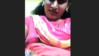 A Tamil trans woman displays her breasts during a video call and masturbates