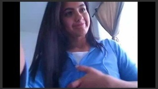 A charming girl flaunts her large, voluptuous breasts in a provocative manner on camera