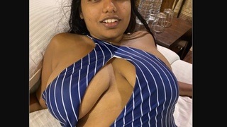 A model with large breasts in an alluring attire