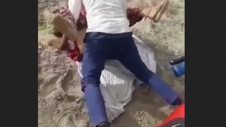 A Rajasthani woman engages in sexual activity with two men in an outdoor setting