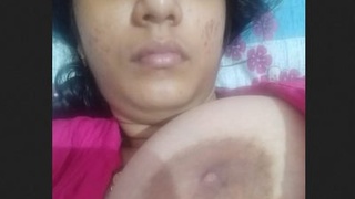 A sultry Desi woman entices with her ample breasts and intimate area