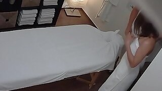 Young Brunette with Glasses Seduced on Massage Table