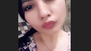 A well-endowed woman proudly displays her large breasts