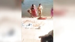 Shameless Desi bhabhi poses topless on the riverbank in XXX video