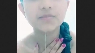 A charming girl takes a bath