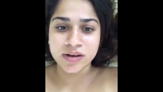 Aroused brunette undresses and misbehaves in her private quarters