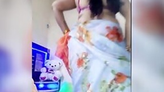 Desi takes off her sari a bit to expose her naked XXX assets at home
