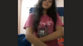 Attractive young woman displays her breasts