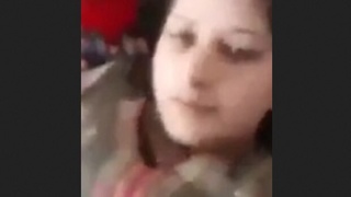 A Pakistani woman with large breasts proudly displays them