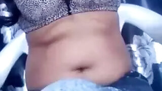 In a bra showing off her armpits and belly button for live teasing