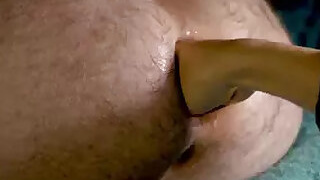 Close-up of her fisting his ass, she sucks his rose