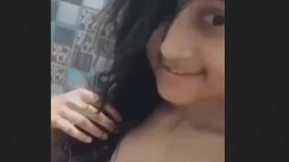 A stunning Asian beauty takes a bath while displaying her charm