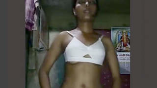 A rural woman undressing and revealing her entire unclothed physique in a rapid manner