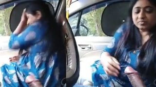 A sultry Indian woman performs oral sex with her partner in a vehicle, captured on personal footage