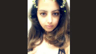 A charming girl enjoys fondling her own breasts