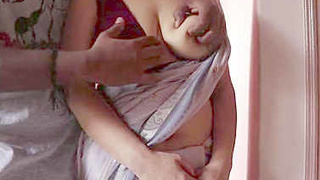 Indian wife with large breasts gets hugged by her husband while wearing a saree